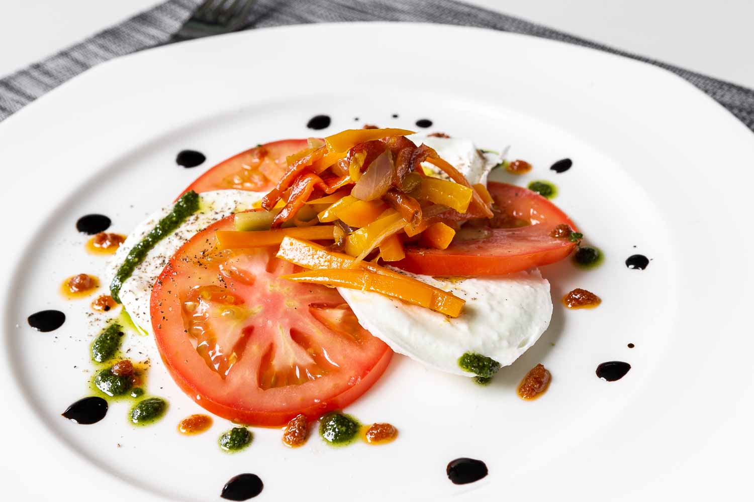 Caprese salad with sauteed vegetables and thyme