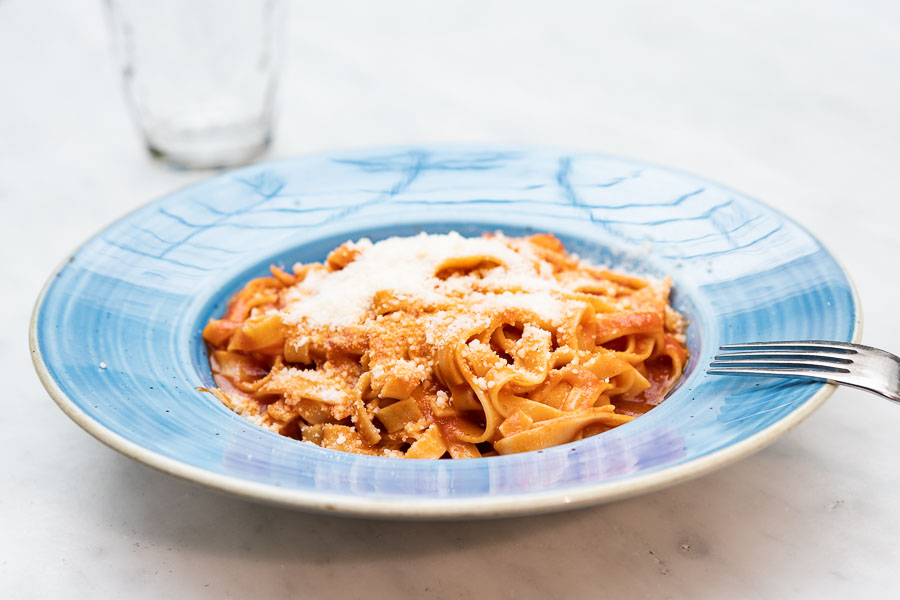 Linguini served with tomato and parmesan cheese