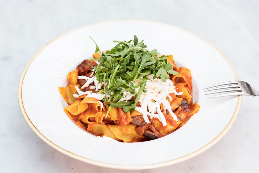Tagliatelle noodles with tomato sauce, aubergine and fresh grated cheese