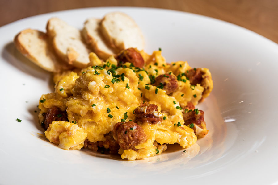 Organic scrambled eggs with chorizo sausage “chistorra” and goat cheese