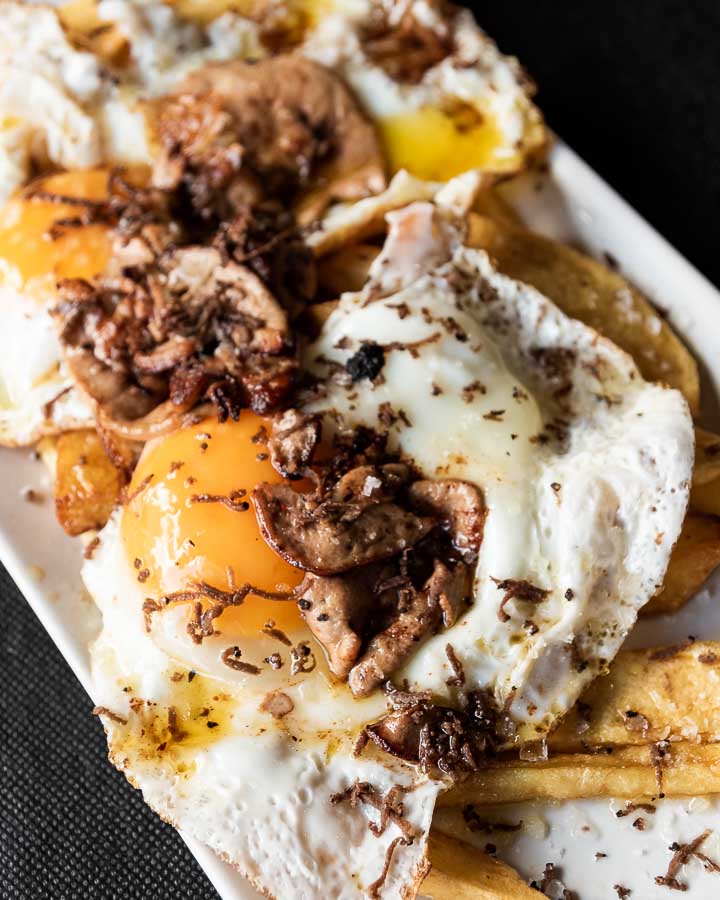 Potatoes with fried eggs and foie gras