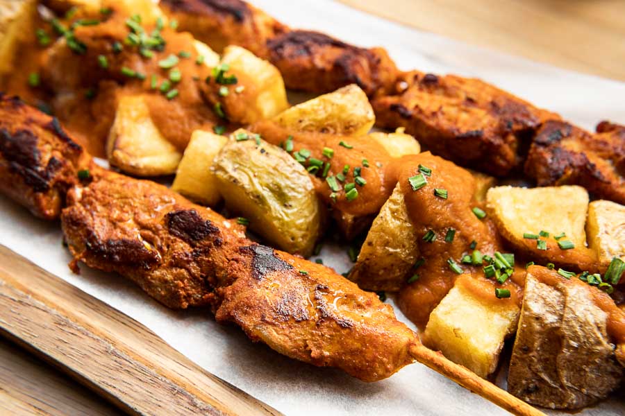 Grilled marinated ibérico pork brochettes with brava potatoes
