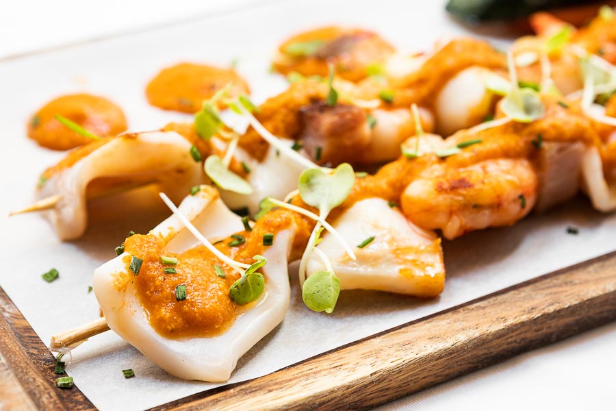 Grilled mediterranean prawn & squid brochettes w/ bacon & veggies