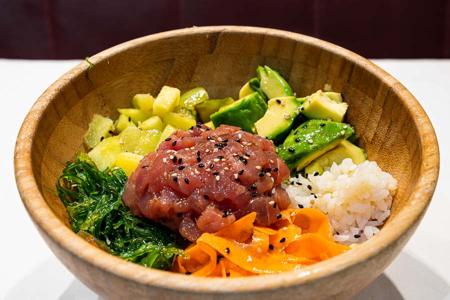 Poke bowl of red tuna with rice, avocado, mango, wakame seaweed