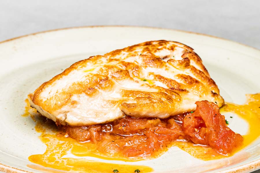 Grilled sea bass with tomato and onion compota