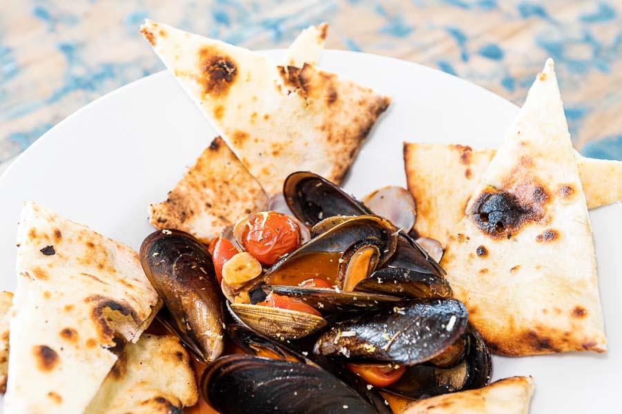 Mussels and clams with seafood sauce and focaccia bread