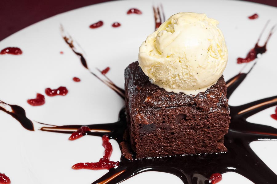 Brownie with nuts and vanilla ice cream
