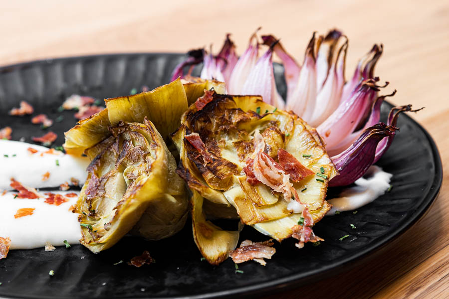 Grilled artichoke flowers w/ potato cream & crispy ibérico ham
