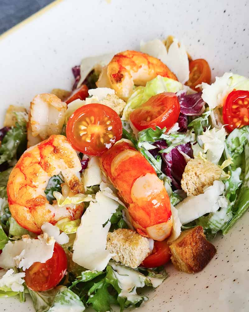 Caesar salad with grilled prawns