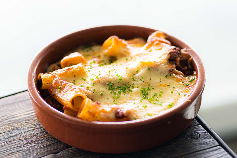 Baked rigatoni with bolognese and melted cheese