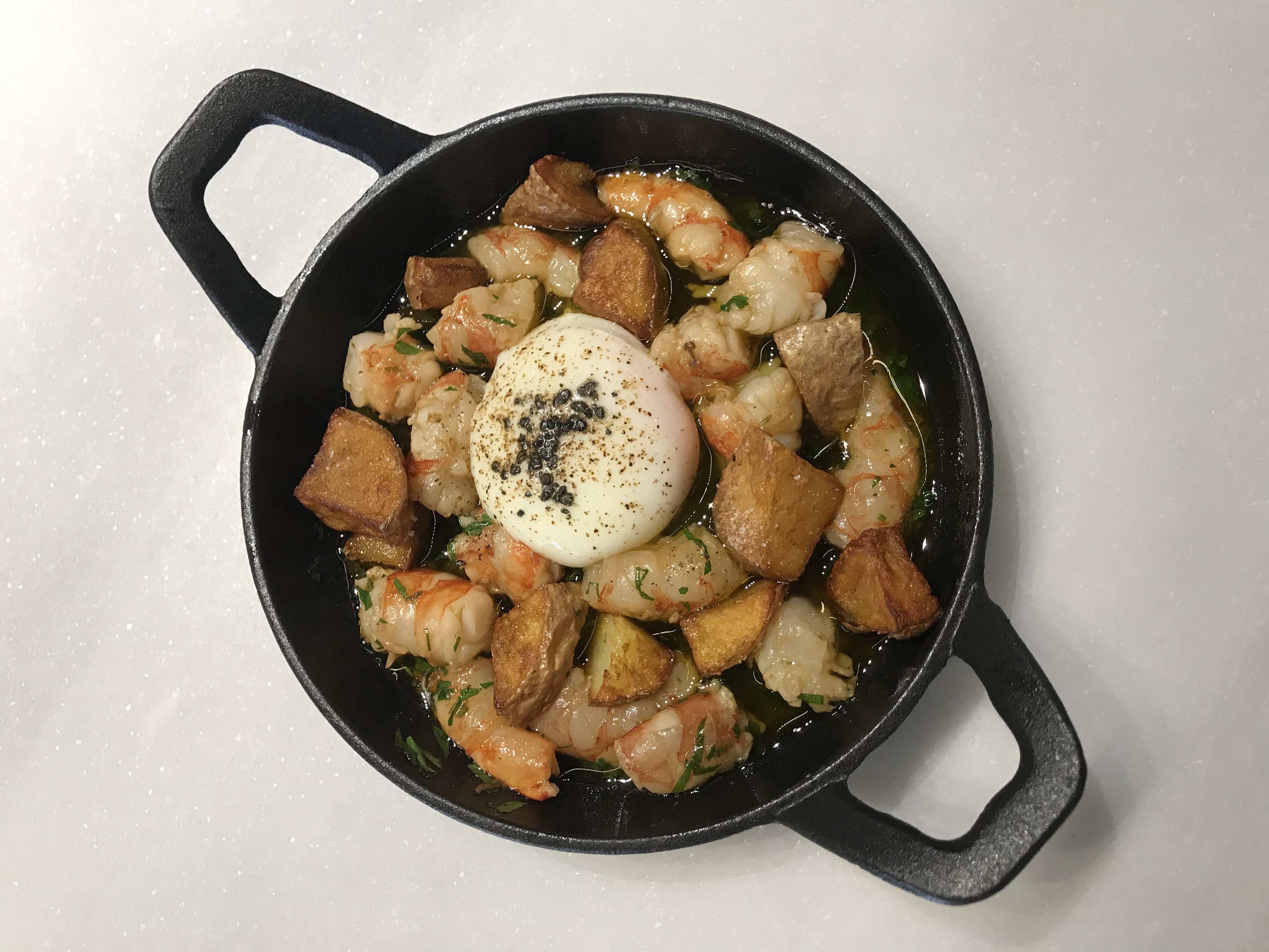 Prawns cooked with garlic-Nikkei style with potatoes and fried egg