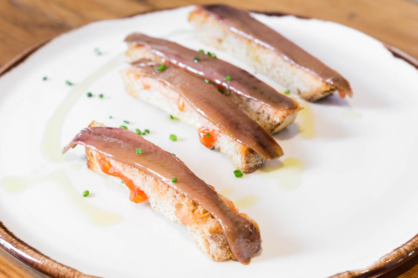 Anchovy over bread with tomato