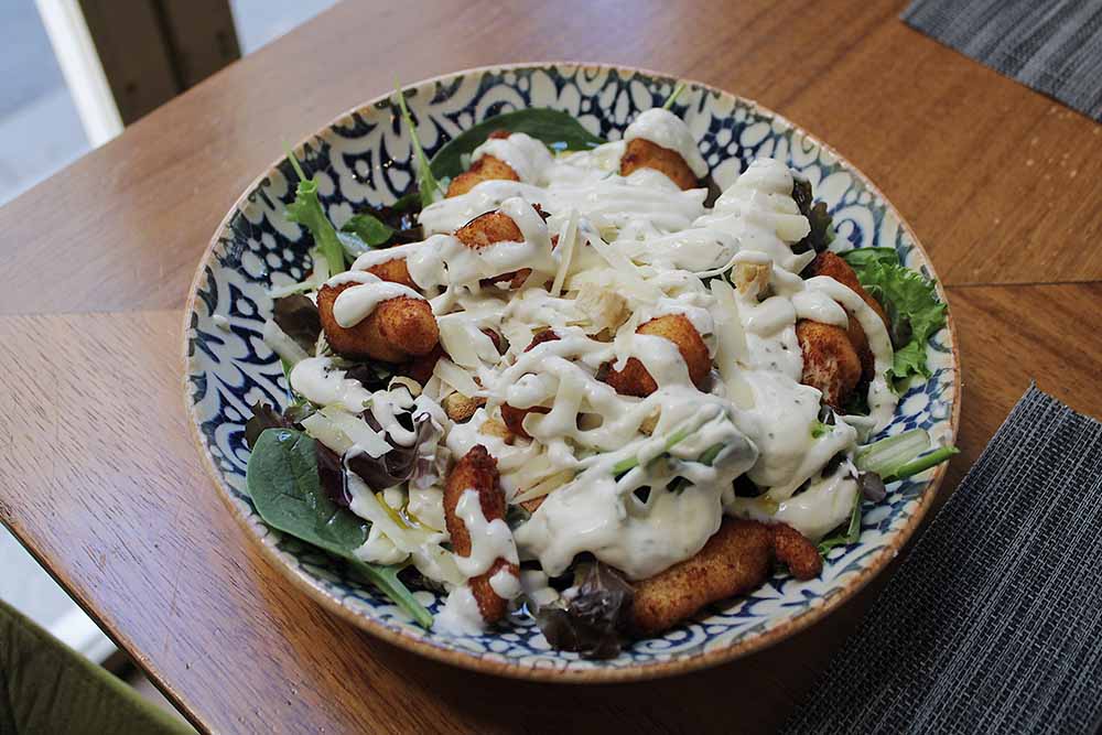 Caesar salad with crispy chicken and Parmesan cheese