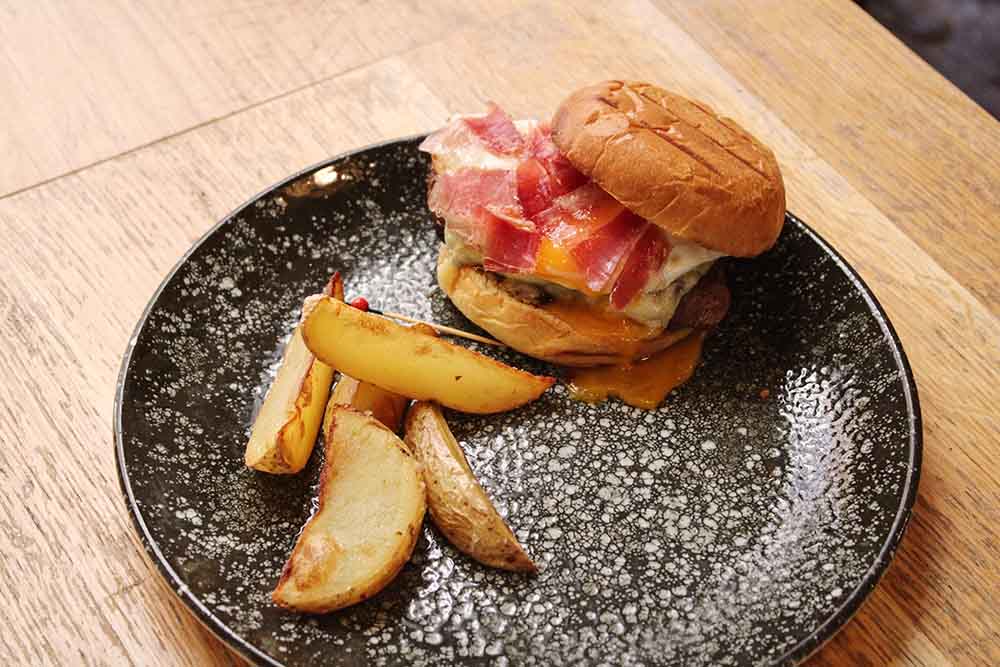 Beef burger with cheddar, fried egg, foie gras and ham