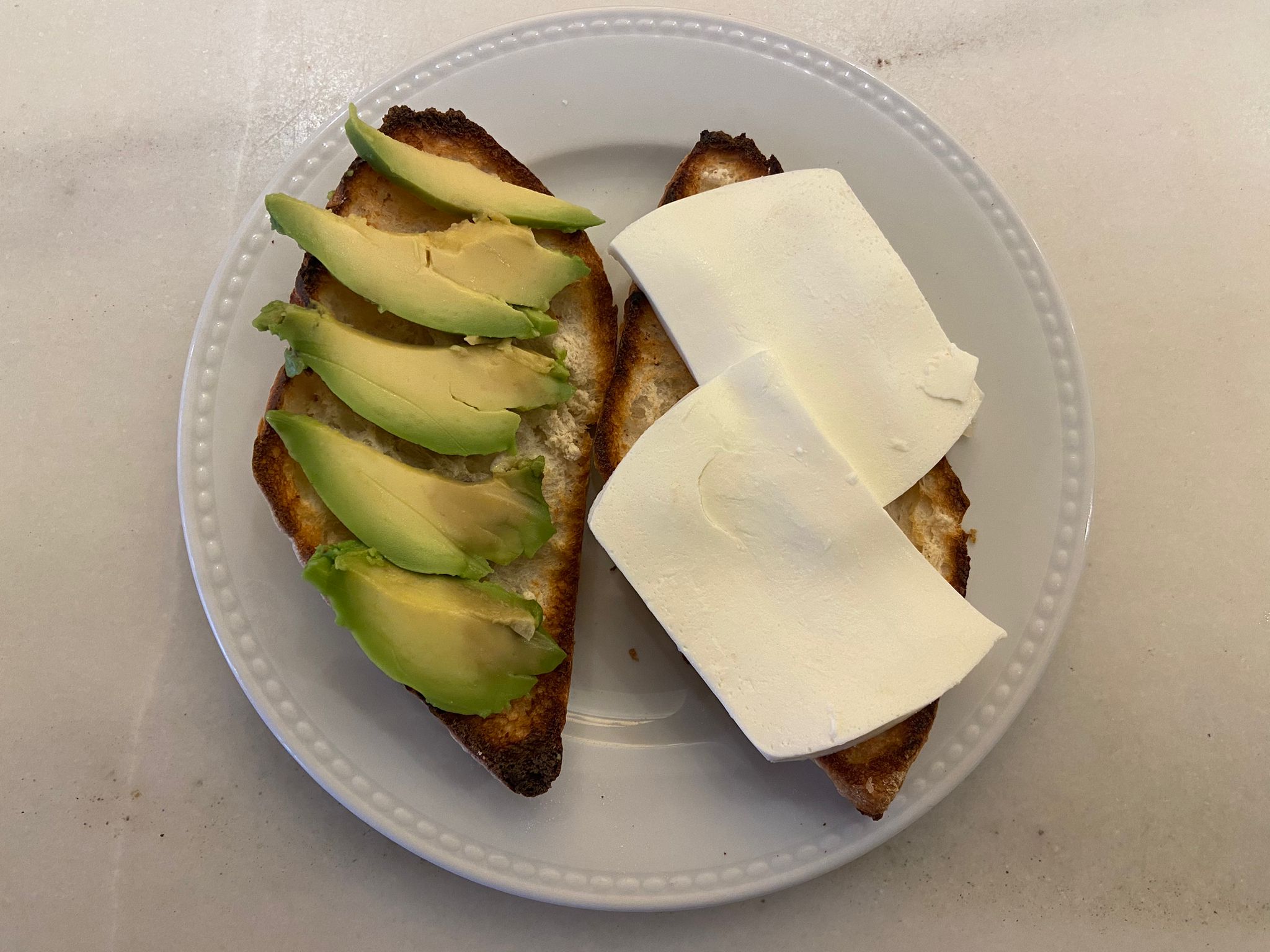 Toast with oil and avocado and fresh cheese