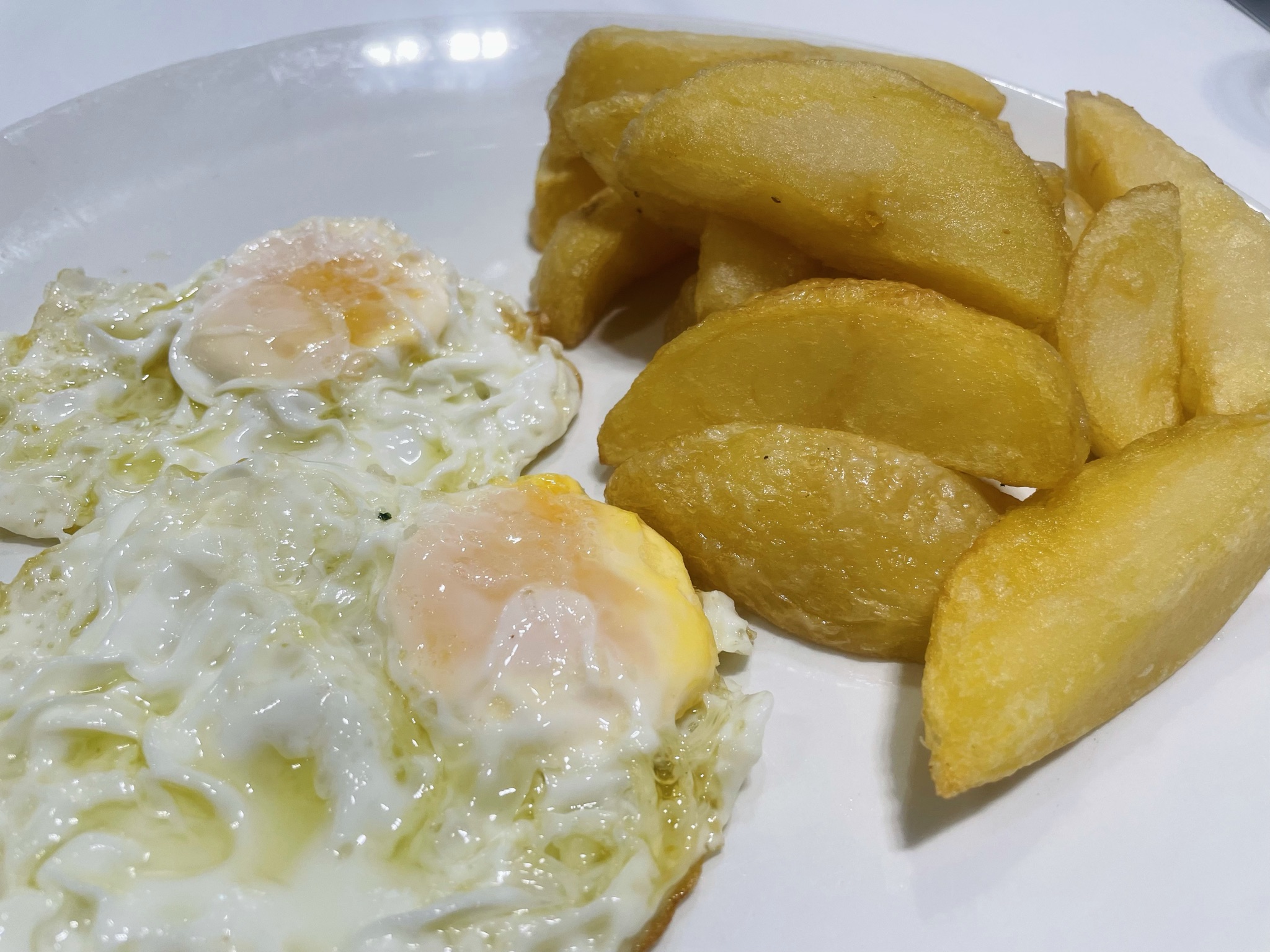 Fried eggs with French fries