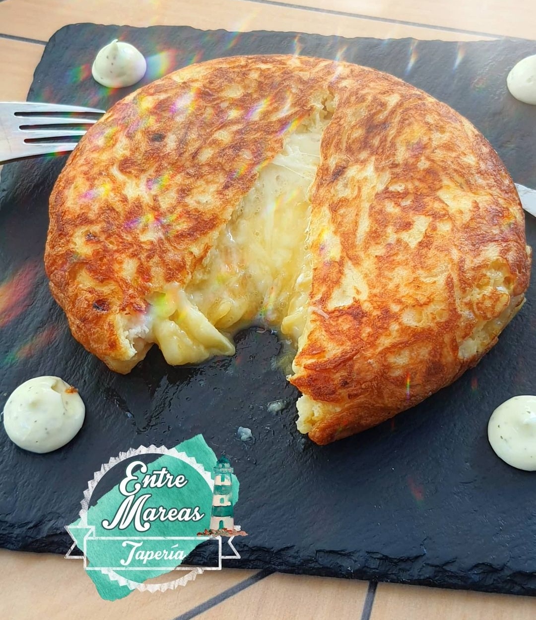 Omelette stuffed with potatoes, mozzarella cheese and caramelized onion