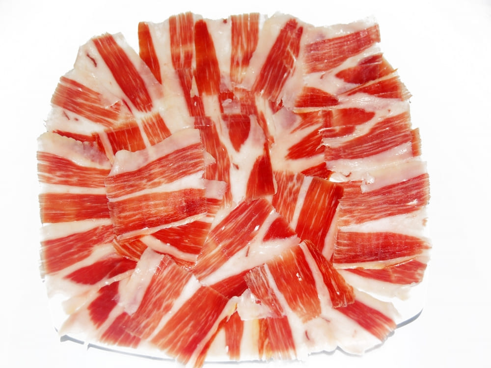 Acorn-fed Iberian ham, toasted bread with raisins and tomato jam