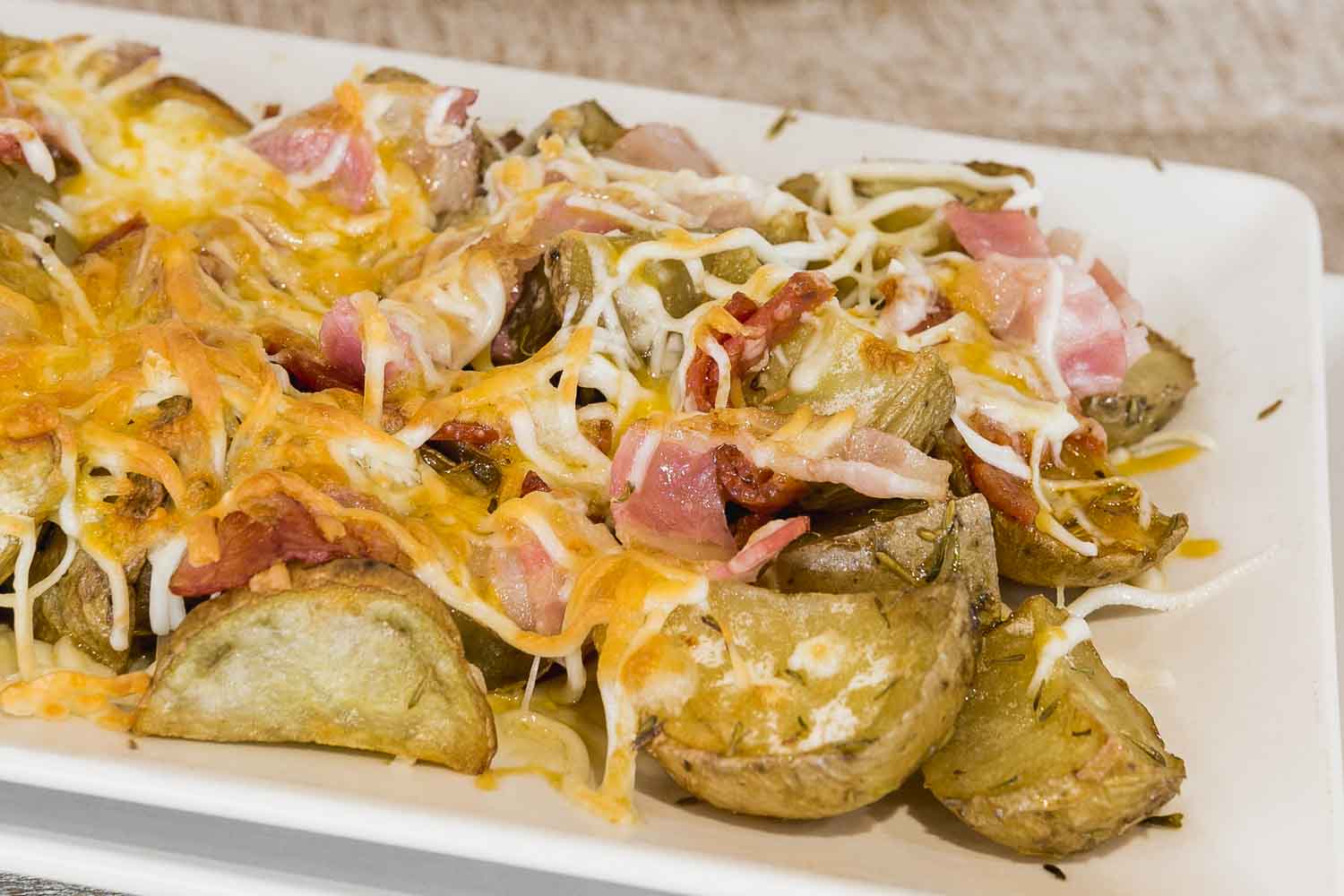 Country potatoes with cheese, bacon and pepperoni