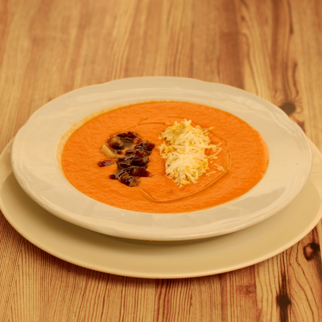 Thick Salmorejo soup with olive oil garnished with chopped