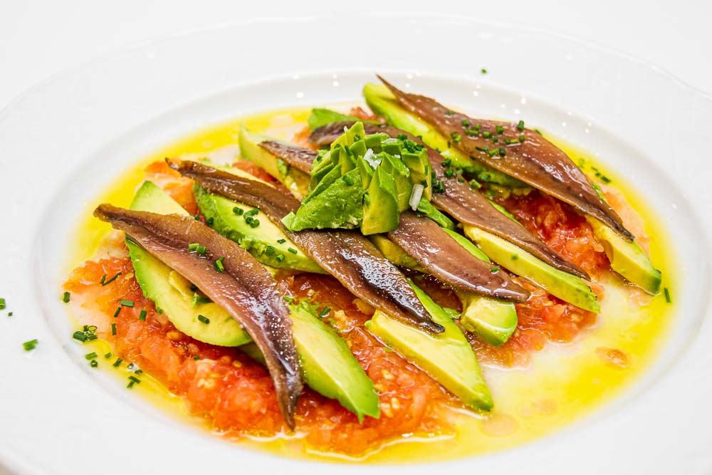 Avocado with anchovies and tomato